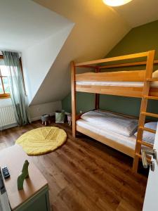 a bedroom with two bunk beds in a attic at Seehotel Losheim in Losheim