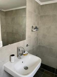 bagno con lavandino e specchio di Acropolis Suite greendom ad Atene