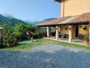 a house with a patio with mountains in the background at B&B Il Ghiro-Country House in Mormanno