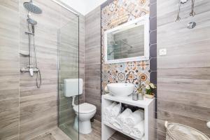a bathroom with a toilet and a glass shower at IPM Apartments in Kaštela +35 photos