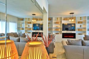 a living room with two couches and a fireplace at IPM Apartments in Kaštela