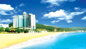 a hotel on a beach next to the ocean at Zhuhai Dehan Hotel in Zhuhai