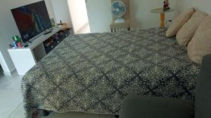 a bedroom with a large bed and a television at Casa Duplex - Garanhuns in Garanhuns