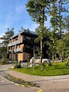 a building with a car parked in front of it at Pajūrio Oazė MG13 in Klaipėda