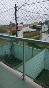 a cage with a fence on top of a field at Casa Duplex - Garanhuns in Garanhuns