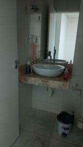 a bathroom with a sink and a mirror at Casa Duplex - Garanhuns in Garanhuns