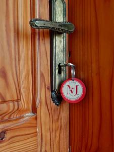 a door with a lock on a wooden door at MJ Farmhouse B&B in Xagħra