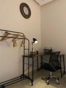 a room with a desk and a chair and a clock at شقة مدخل خاص دخول ذاتي in Riyadh