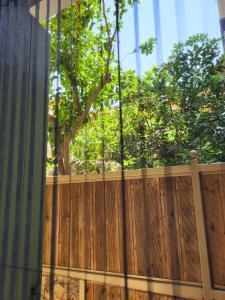 a wooden fence with a tree in the background at BELLA VITA boutique hotel lefkada in Lefkada Town