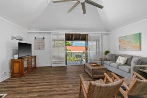 a living room with a couch and a tv at 2Br 2Ba Poipu Condo, Access to Poipu Beach Athletic Club KP81 in Koloa