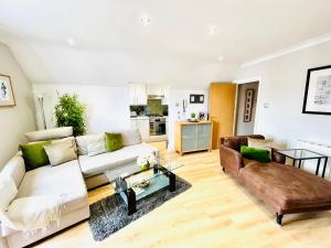 a living room with a couch and a table at Bright and Breezy in Portsmouth