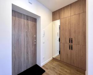a room with wooden cabinets and a hallway at TideHaven in Palanga