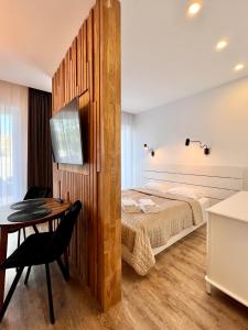 a bedroom with a bed and a table in a room at TideHaven in Palanga