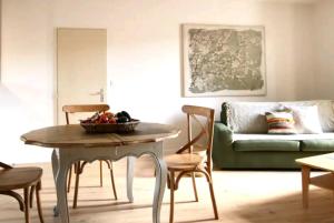 - un salon avec une table et un canapé dans l'établissement Appartement 72m2 cosy centre ville, à Saint-Rémy-de-Provence