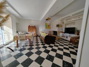 a living room with a checkered floor at Maison provençale rénovée in Pernes-les-Fontaines