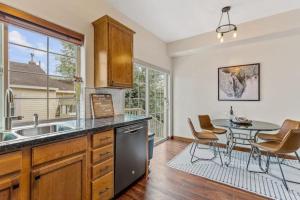 a kitchen with a sink and a table with chairs at Verde St A in Flagstaff