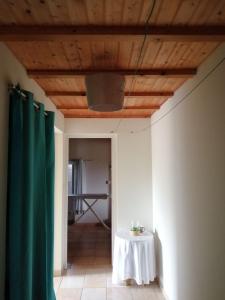 a room with a table and a wooden ceiling at Chambre privée ste cecile tout confort in Sainte-Cécile