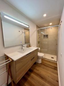 a bathroom with a sink and a toilet and a shower at Quinta do espelho d'agua, Estudio in Reguengo Grande