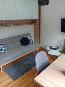 a living room with a couch and a table at Apartman Bjelašnica in Bjelašnica