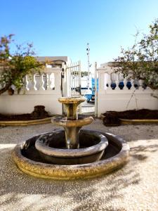 a fountain in the middle of a courtyard at Villa La Torretta Luxury B&B - Adults Only - in Rimini