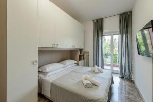 a bedroom with a bed with two stuffed animals on it at RESIDENZA ERES EUR in Rome