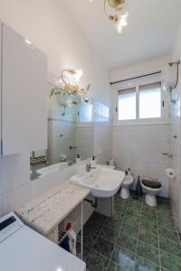 a bathroom with a sink and a toilet and a mirror at RESIDENZA ERES EUR in Rome