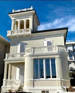 a white building with a balcony on top of it at Villa La Torretta Luxury B&B - Adults Only - in Rimini