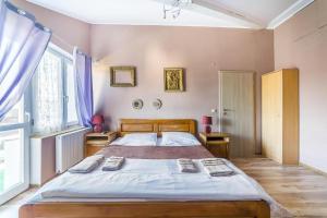 a bedroom with a large bed and a large window at SŁONECZNIK in Ostrowo