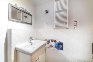 a white bathroom with a sink and a mirror at SŁONECZNIK in Ostrowo +31 photos