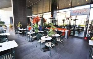 un restaurante con mesas y sillas frente a un edificio en Luxury 1+1 apt in Sinpaş Queen Bomonti en Estambul
