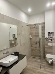 a bathroom with a sink and a glass shower at Villa Night Pearl in Trogir