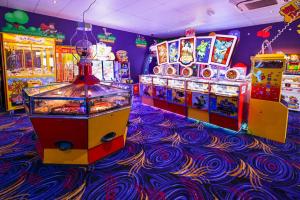 a arcade with several games in a room at A&A Caravan Holidays in Leysdown-on-Sea