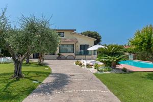 a house with a swimming pool in a yard at Casa dei Sogni - Exclusive Suite in Villa in Lido di Ostia