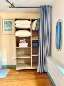 a room with a book shelf with towels and a curtain at Apartment with mountain views in town centre in La Roche-sur-Foron