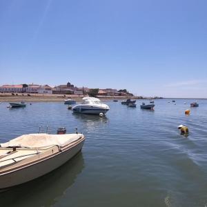 un groupe de bateaux dans une masse d'eau dans l'établissement GuestBoat Milagre, à Faro