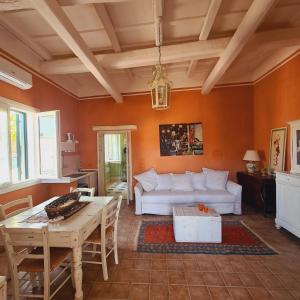 a living room with a white couch and a table at Villa Irene in Marsala +22 photos