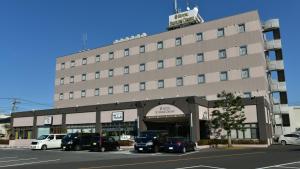 a large building with cars parked in front of it at Hotel Sunrise Choshi - Vacation STAY 73475v in Choshi