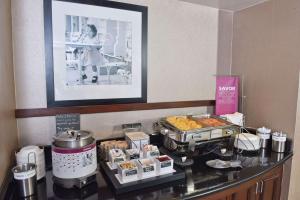 a breakfast buffet with pastries and desserts on a counter at Hampton Inn & Suites Alexandria in Alexandria