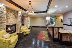 a lobby with a fireplace and couches and a bar at Hampton Inn by Hilton Augusta Fort Eisenhower in Augusta