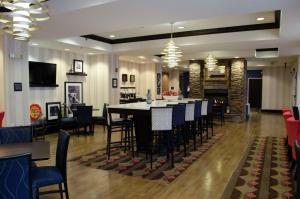 a dining room and living room with a table and chairs at Hampton Inn Thomson in Thomson