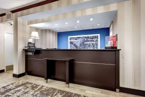 a hotel lobby with a reception desk and blue walls at Hampton Inn Amelia Island in Fernandina Beach