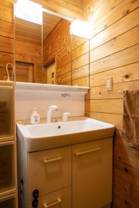 a bathroom with a sink and a mirror at Log house Grazzi - Vacation STAY 70263v in Nasu-yumoto