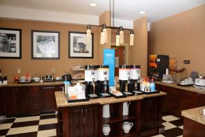 a room with a counter with bottles of wine on it at Hampton Inn Americus in Americus