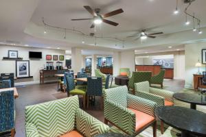 a restaurant with tables and chairs and a ceiling fan at Hampton Inn Bonita Springs Naples North in Bonita Springs