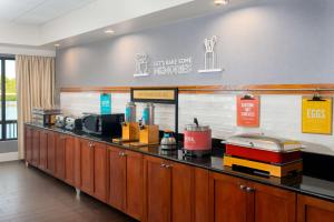 a restaurant with a counter with many items on it at Hampton Inn Bonita Springs Naples North in Bonita Springs