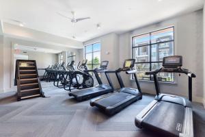 a gym with a row of treadmills and ellipticals at Luxe Suite-King Bed-Fast WiFi-6mi to CLT in Charlotte