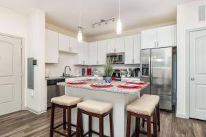 a kitchen with a large counter with stools in it at Luxe Suite-King Bed-Fast WiFi-6mi to CLT in Charlotte