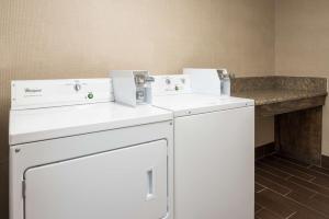 two washing machines in a room with a counter at Hampton Inn Bonita Springs Naples North in Bonita Springs