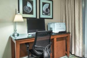 a room with a desk with a computer and a chair at Hampton Inn Bonita Springs Naples North in Bonita Springs