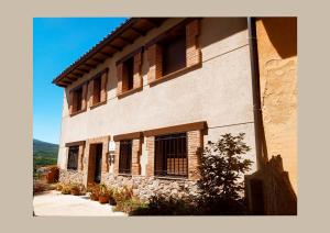 a building with shuttered windows on the side of it at El Balcon De Cabezuela Valle del Jerte in Cabezuela del Valle